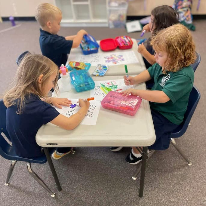 Young Kardia students coloring.