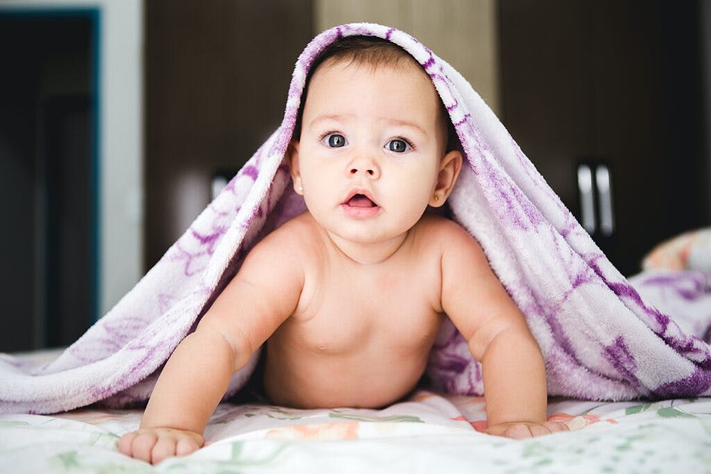 Baby with blanket on head