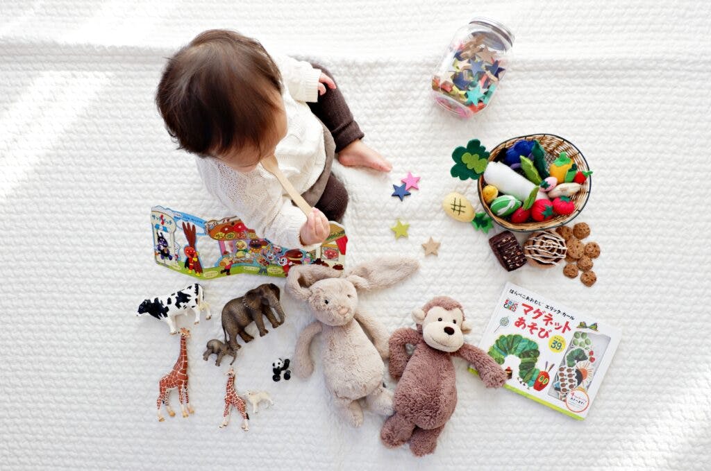 Toddler playing with books and toys